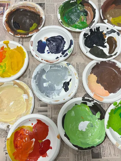 The beautiful mess of creation. Another look at my paint palettes, filled with the rich colors that brought the coffee-themed mural to life.