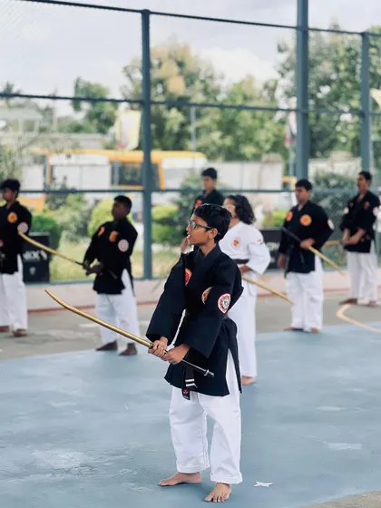 A young martial artist with a focused gaze, ready for action at the National Samurai Championship.