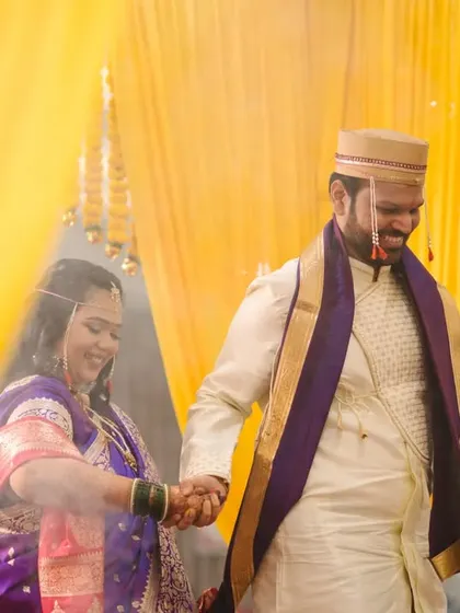 The couple holding hands as they walk through a cloud of holy smoke, a beautiful and symbolic moment from their wedding ceremony.