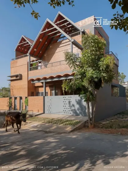 The Madhura house seen from the street, with a local cow wandering past. I design homes to be a part of their context, reflecting the life and rhythm of the neighborhood.