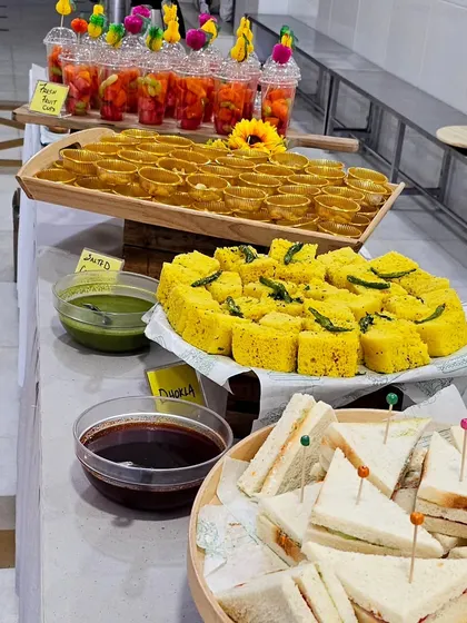 A full view of our breakfast spread for a Gurudwara event, featuring fresh fruit cups, dhokla with chutney, and mini sandwiches.
