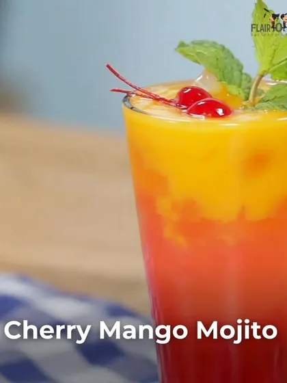 A layered Cherry Mango Mojito. This vibrant and fruity cocktail is as beautiful to look at as it is delicious to drink.