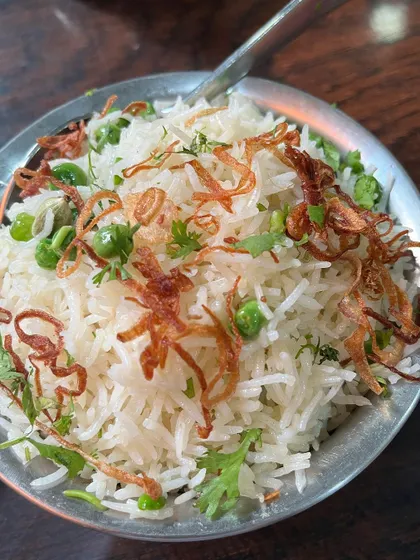 A bowl of our fragrant Matar Pulao. It's the perfect accompaniment to any of our rich curries or can be enjoyed on its own.