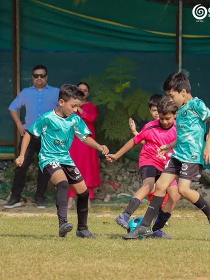 A player from GSC battles for the ball against a Manav Rachna FC opponent.