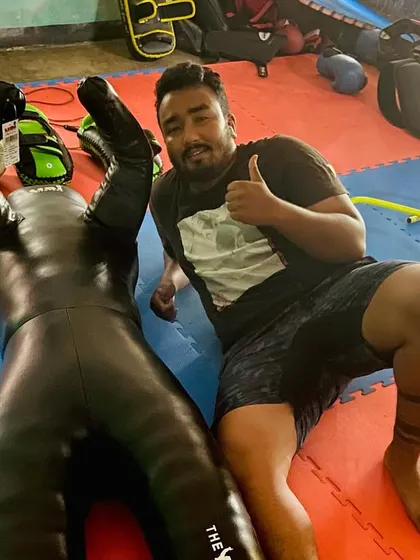 Me with my grappling dummy on the balcony where it all started. Even from the beginning, I invested in the right tools to drill techniques and build a strong foundation.