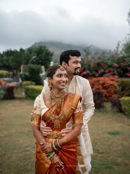 A stunning portrait of the couple, with the bride's intricate jewelry and the beautiful natural scenery in the background.