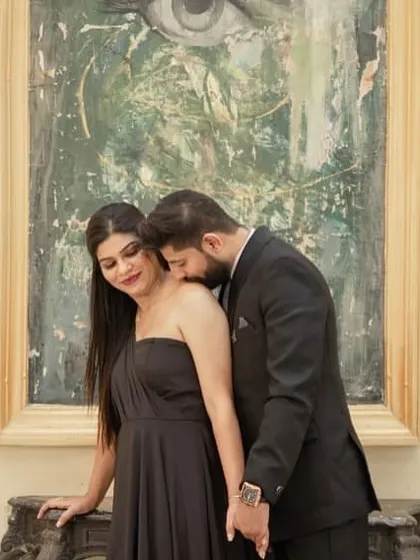 An intimate close-up of the couple, showcasing the elegant black gown.
