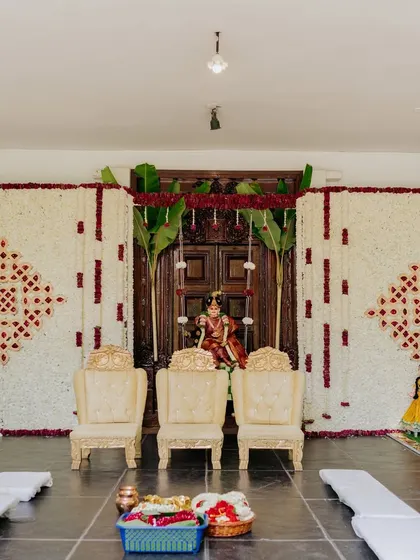 A traditional setup for the Gauri Pooja ceremony, with a beautiful floral backdrop.