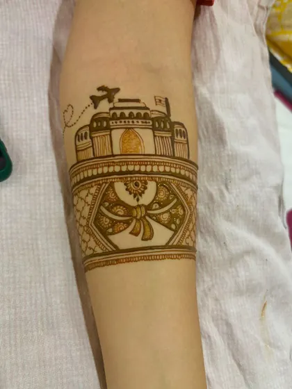 A close-up of the custom travel-themed armband. The airplane and the Taj Mahal are drawn with fine lines, showing the level of detail I can achieve.