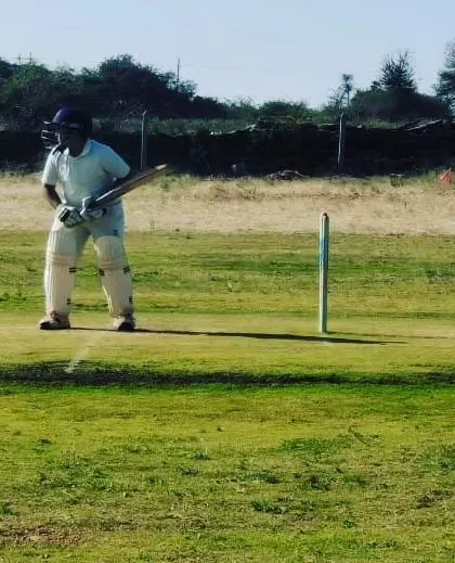 A batsman takes his stance, ready to face the bowler during a practice match in Chitradurga.