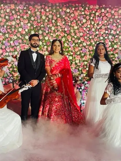 Make your wedding entrance truly magical. We create storybook moments, like this beautiful angel entry where performers with violins welcome the couple, surrounded by ethereal smoke for a dreamy, romantic atmosphere.