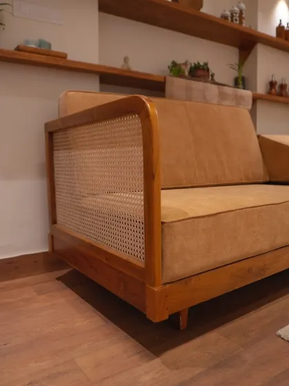 My custom sofa set in a client's home. The blend of rattan sides, luxurious fabric upholstery, and a robust teak wood frame creates a refined and enduring centerpiece.