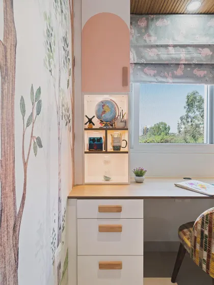 A close-up of the study desk details, including the arched pink cabinet and illuminated display shelf for treasured items.
