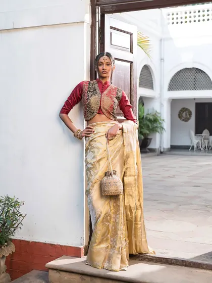 A beautiful example of layering in ethnic wear. I styled this cream saree with a contrasting maroon embroidered jacket, creating a unique and regal look perfect for a winter wedding.