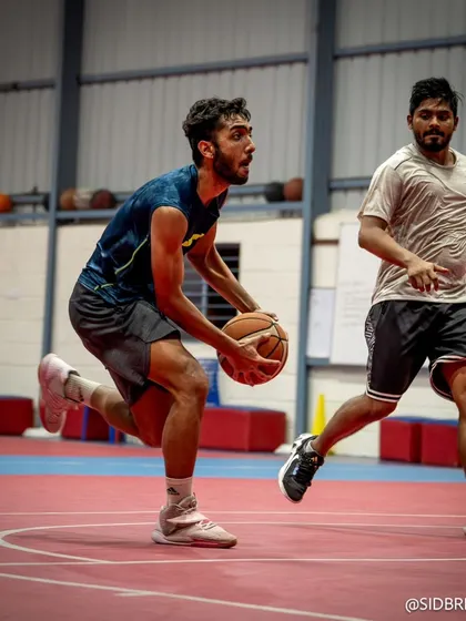 An intense moment of a player driving past a defender, showcasing the speed and agility honed in our training programs.