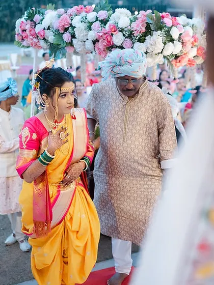 The bride's walk down the aisle, her Nauvari drape looking elegant and perfectly styled.