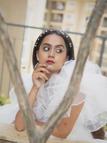 A close-up shot highlighting the delicate pearl headband and the soft, romantic feel of this unique white gown.