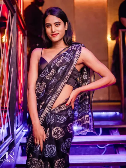 A guest looking stunning in a saree, proving that traditional wear can be club-ready.