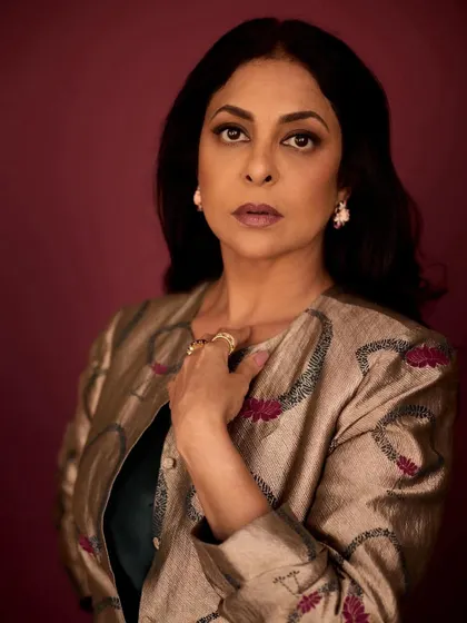 This pose showcases the regal elegance of the brocade jacket, paired with statement Tyaani jewelry.