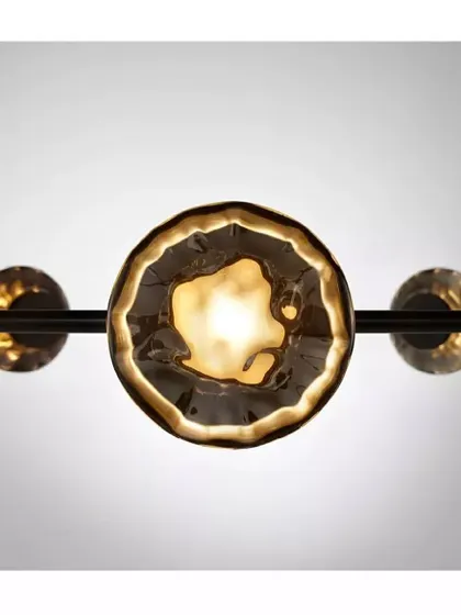 A close-up of a Ceto glass shade, its surface beautifully capturing and refracting the light, reminiscent of the sun on water.