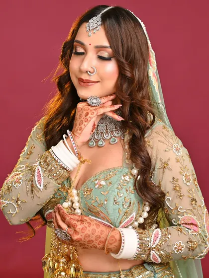 A full-length pose that highlights the entire ensemble. The makeup remains a key feature, tying the whole look together with its soft and elegant tones.