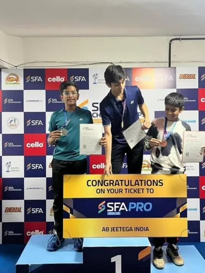 Aarav Chettiar on the podium after securing 2nd place in the U-15 Singles at the SFA Championship, showcasing his all-around skill.