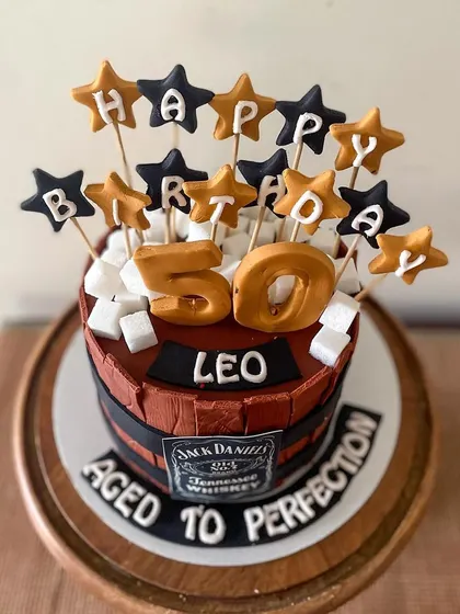 A close-up showing the "Happy Birthday" star toppers and sugar cube "ice".