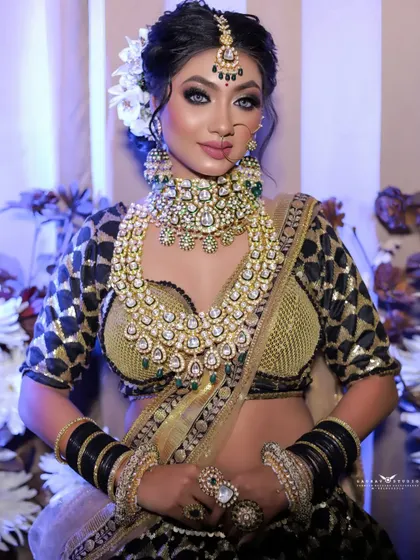A confident and engaging portrait of the bride. Her direct gaze and poised posture make the heavy, layered jewellery and rich outfit look effortlessly elegant.