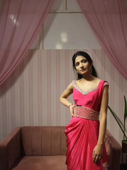 The pink draped saree is perfect for a daytime wedding or a cocktail party.