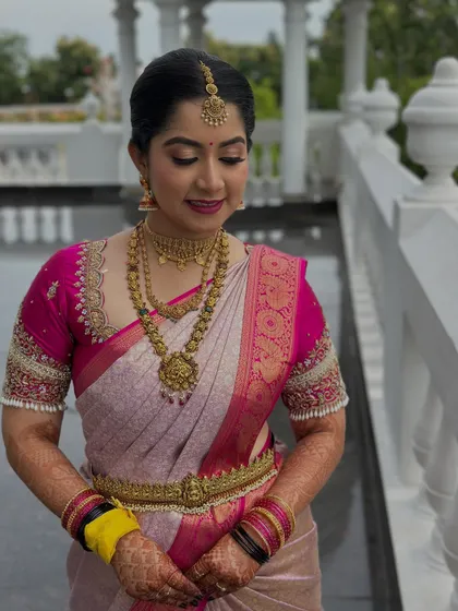 A candid moment of the bride, her soft glam makeup looking flawless. The eyeshadow is blended to perfection, and her skin has a beautiful, natural-looking glow.