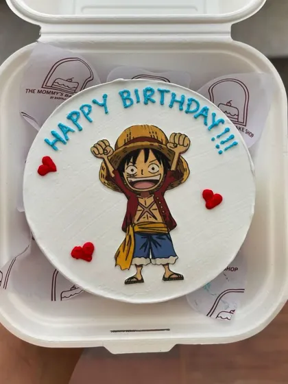 A bento cake for an anime fan, featuring Luffy from One Piece. Edible image toppers are a great way to include any character you can imagine.