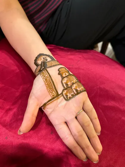 An in-progress shot showing the outline of the initial and elephant designs before the intricate details are filled in.