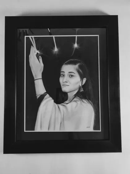 The finished piece in a simple black frame, which enhances the contrast and drama of the composition.
