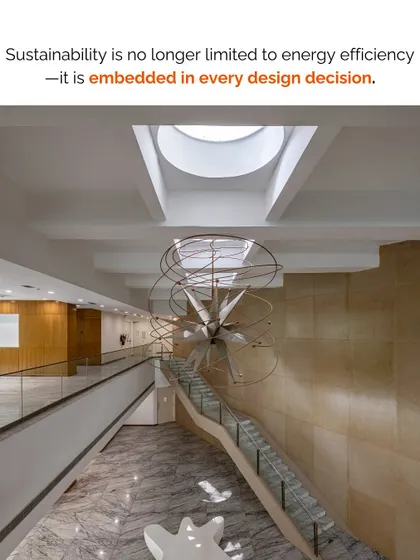Sustainability is embedded in every design decision. The grand atrium and sculptural staircase shown here are not just aesthetic choices; they are part of a larger system that includes daylighting and passive ventilation.