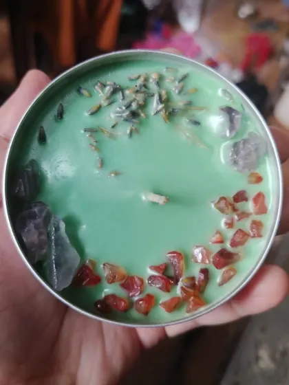 This is hand-poured magic in a tin. I created this soothing green candle with a mix of carnelian for creativity, amethyst for calm, and dried lavender for peace.
