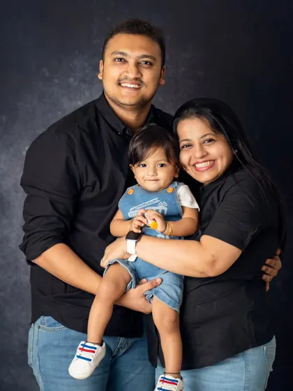 A classic family portrait where everyone is smiling and connected. We coordinate outfits and poses to create a polished yet natural look for your family photos.