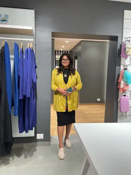 An Indo-Western office look for Day 2 of the styling project. Layering a bright jacket over a classic black dress is a great way to add personality to your workwear.