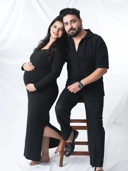 A classic and stylish couple's portrait. The all-black outfits create a chic, coordinated look that is both modern and timeless.