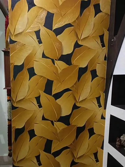 A bold wallpaper with large, golden leaves on a dark background. This luxurious design is perfect for making a statement in a small space or as a feature panel.