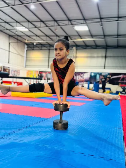 Strength and balance combined. This young gymnast holds a challenging split on a dumbbell, showcasing incredible core control and stability that we build through a variety of conditioning exercises.