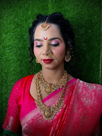 A classic South Indian bridal look with temple jewellery and a bright pink saree. Our students learn to create authentic traditional looks, including the specific bindi style and makeup palette.