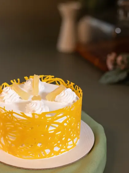A tropical delight. My Pineapple bento cake is light, fresh, and decorated with a bright yellow chocolate cage for a fun, modern look.