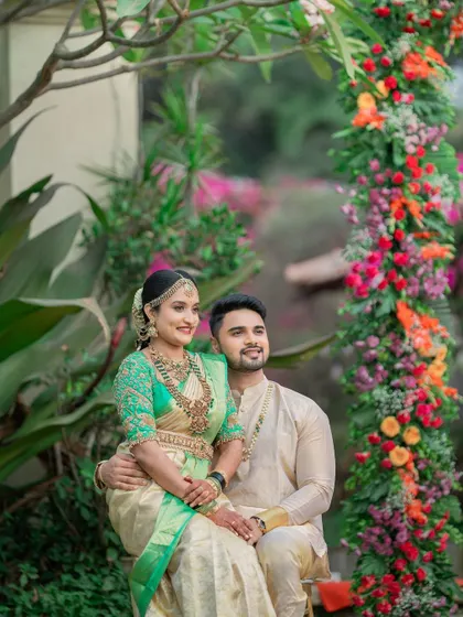 A beautiful portrait of the couple in a lush garden setting, their traditional attire complementing the natural beauty around them.