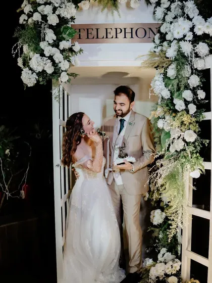 The couple enjoying their unique audio guestbook, a fun and interactive element for their wedding day.
