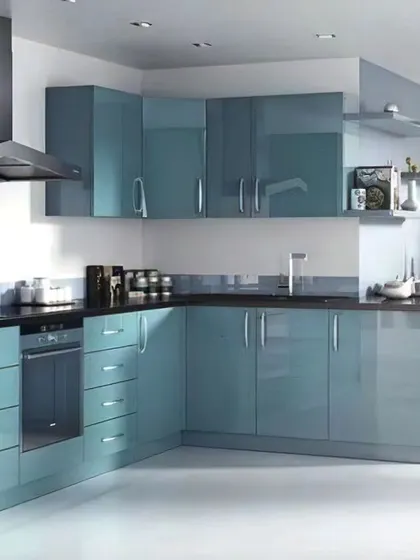 This L-shaped kitchen features high-gloss blue-grey cabinetry for a sleek, futuristic look. The layout is designed for maximum efficiency in a compact space.