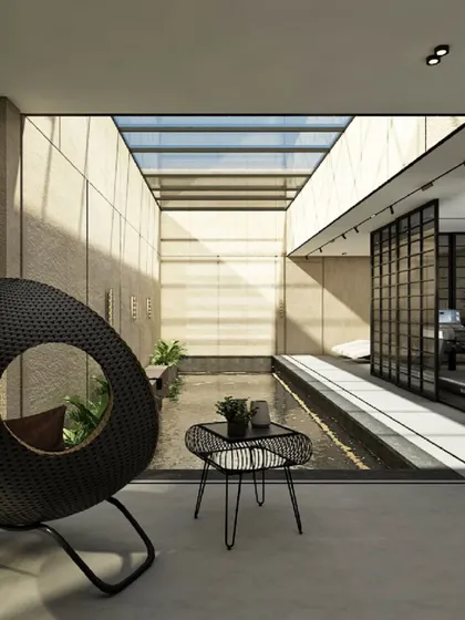 This terrace pool area in Raichur is designed for tranquility. A large glass roof floods the space with natural light, while a modern rattan chair offers a sophisticated spot to relax by the serene indoor pool.