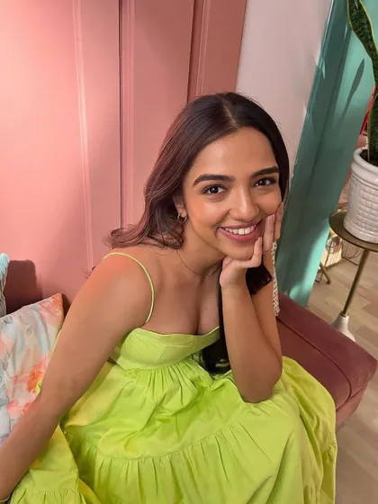 A happy, smiling shot of Ahsaas Channa in the bright lime green dress.