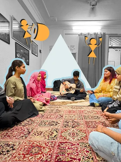 A group of girls in an after-school session learns guitar. We are committed to creating inclusive spaces where girls are encouraged to pick up instruments and express themselves musically.