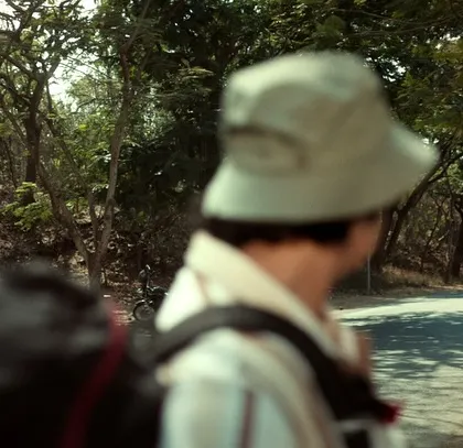A shot focusing on the backpacker character, emphasizing the journey aspect of the Nescafé commercial.