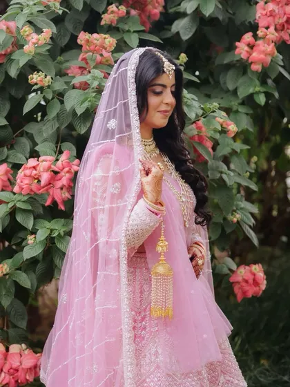 A soft and magical look for a fairytale bride. The flushed cheeks, glass skin, and the softest hues of pink on the lehenga and makeup create a look that is pure elegance.